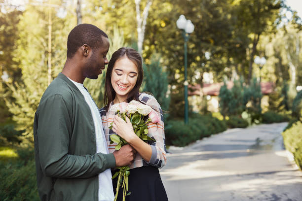 istock Man giving flowers for his beautiful girlfriend 912928952