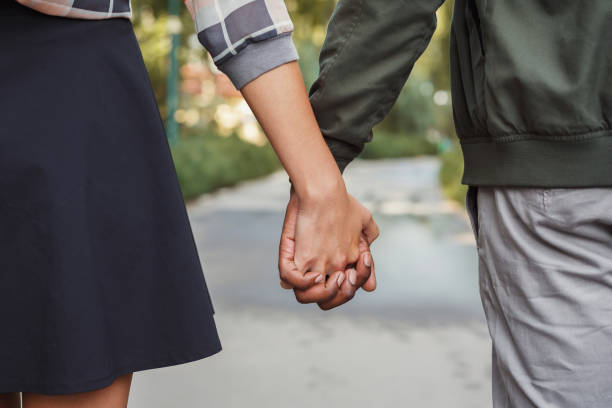 istock Multiethnic couple in love walk in park closeup 912929120