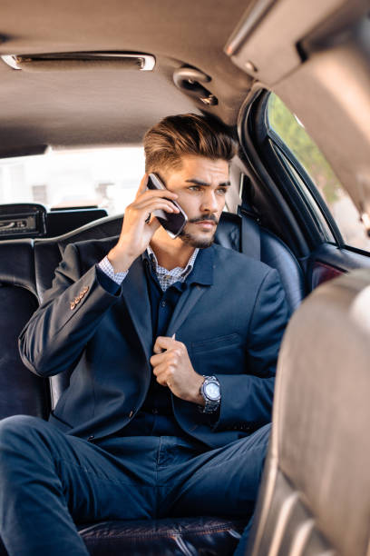 istock Businessman sitting in limousine 912931230