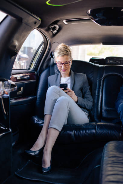 istock Business woman texting in limo 912931656