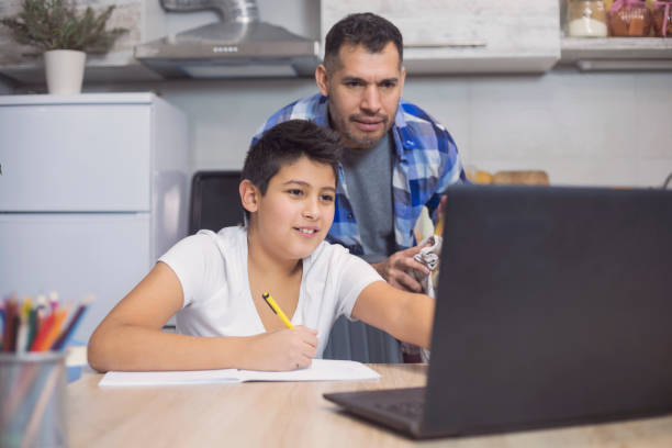 Winning Team Father is helping his teenager son to study homework stock pictures, royalty-free photos & images