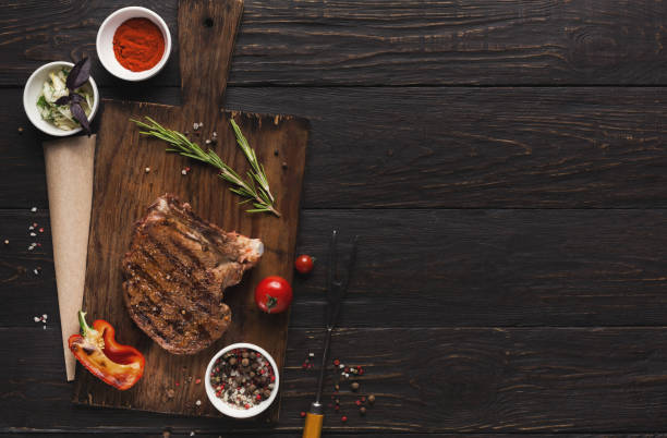 istock Grilled meat and vegetables on rustic wooden table 912932392