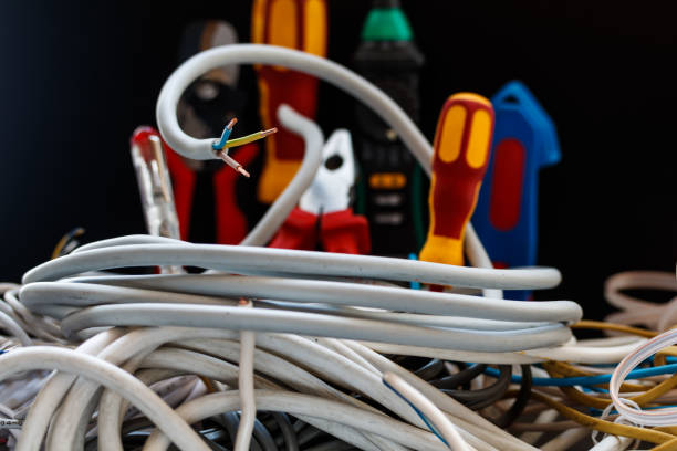 istock electric wires and tools on a black background 912932816