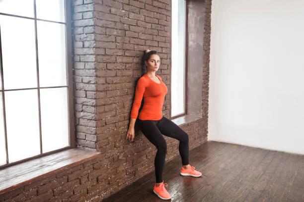 Balancing exercise. Activity woman looking at camera and doing workout stock photo