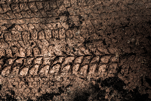 Close-up of water splashing on vehicle tyre against black background.