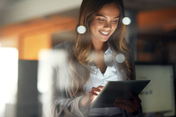 Working hard no matter the time Shot of a young attractive businesswoman working late at night in a modern office one business woman stock pictures, royalty-free photos & images