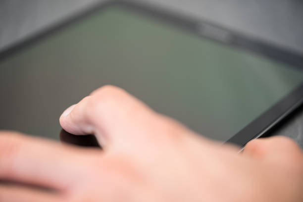 istock Person using a Tablet with their fingers 912944592