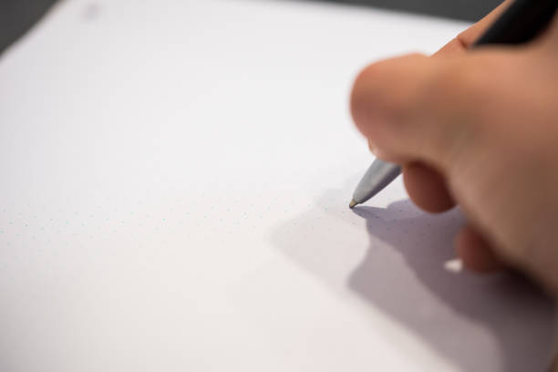 istock Person writing with their right hand 912945060
