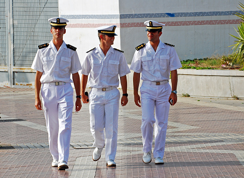 Three young cadets from the Naval Academy of Spain walking in the promenade of Melilla during a  short visit to this Spanish enclave.