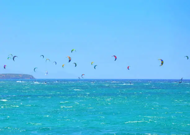 Photo of Many kiteboarding kite surfers in the distance near on Punda beach on Paros island