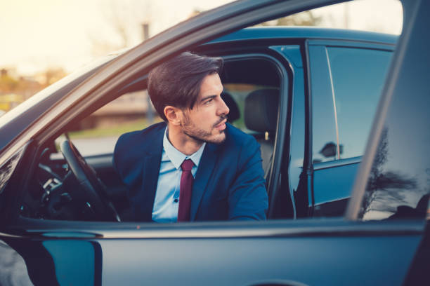 Businessman opening the car door Young man looking at view through the open car door disembarking stock pictures, royalty-free photos & images