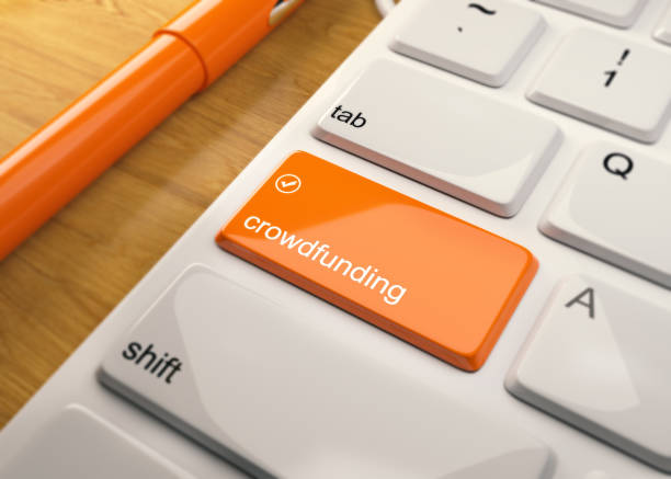 istock White Keyboard With Crowdfunding Button On Wood Table 912952896