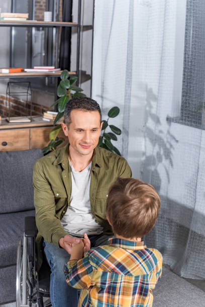 istock father in wheelchair and son 912954354