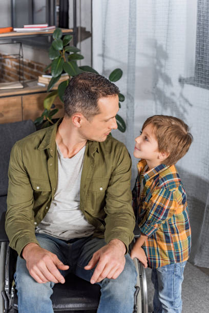 istock father in wheelchair and son 912954858