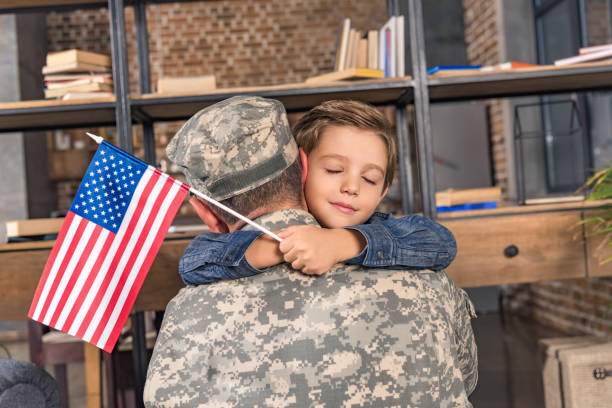 istock military father and son embracing 912960202