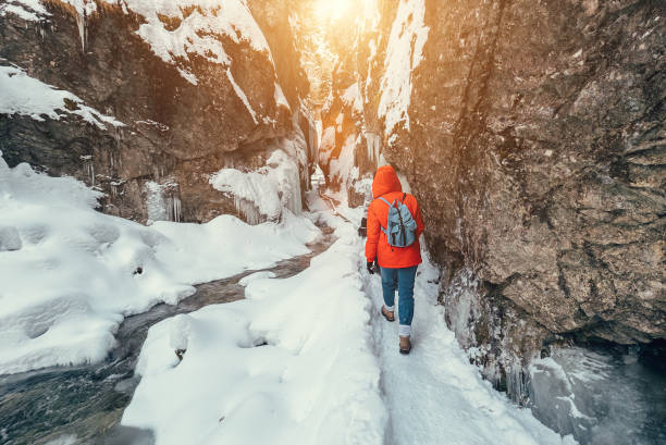 Winter traveler in snow mountain canyon