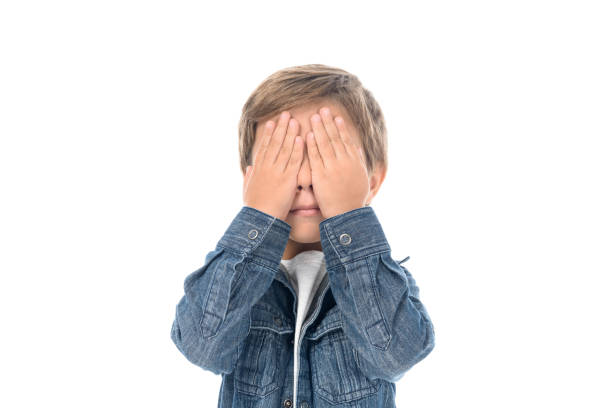 istock little boy covering eyes with hands 912972288