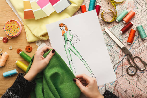 istock Female fashion designer working with fabric sample and drawn illustration 912986208