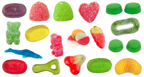 Set of candy of different shapes, colors and flavors on white background