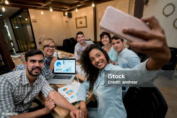 Happy Group Of Coworkers Taking A Selfie At A Creative Office Stock Photo - Download Image Now
