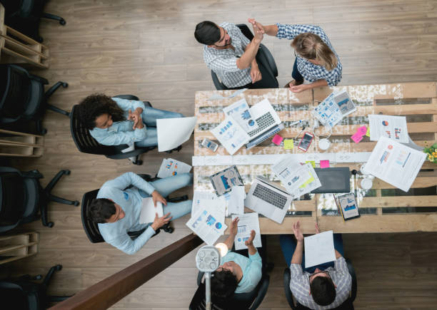 istock Excited group of people celebrating an achievement at a creative office 912986716