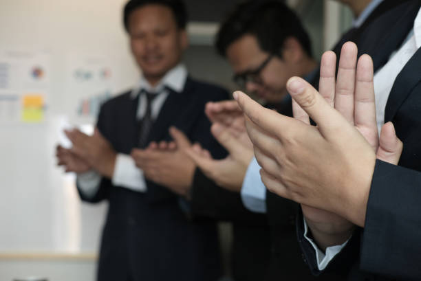 istock cheerful businessman applauding at conference. successful business team clapping hands for great work 912990276