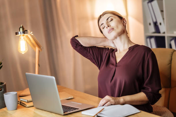 istock Tired businesswoman massaging her neck 912990870