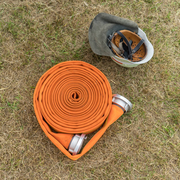 istock fire hose and safety helmet 912993162