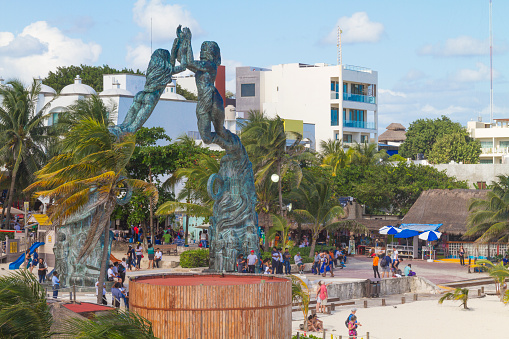 Playa del Carmen, Mexico - December 29, 2017: Mayan monument in front of the beach makes Playa del Carmen a family-friendly Mexican Riviera travel destination.