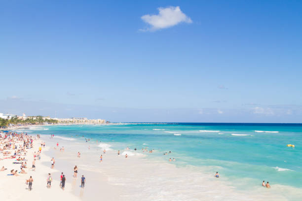 Playa del Carmen, Mexico - December 29, 2017: Tourists enjoying the beach at sunny day at Riviera Maya.