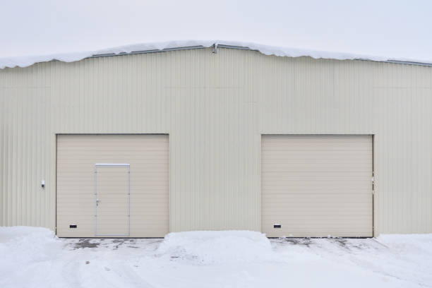 istock Warehouse lined with metal profiles with automatic gates on a winter day 912996176