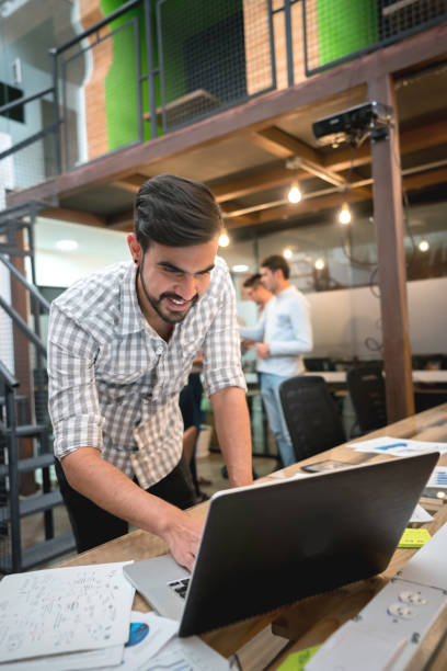istock Happy man working online at a creative office 912996394