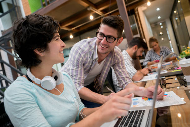 istock Couple of people working as a team at a co-working space 912996452