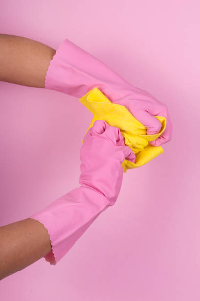 istock Dishwashing gloves and yellow cleaning rag isolated on white background 912996974