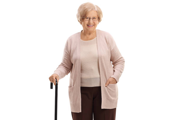 istock Elderly woman with a walking cane looking at the camera and smiling 913006366