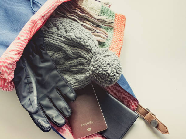 istock long holiday travel flat lay concept from winter cloth item pack in blue backpack and put on isolated white background 913007264