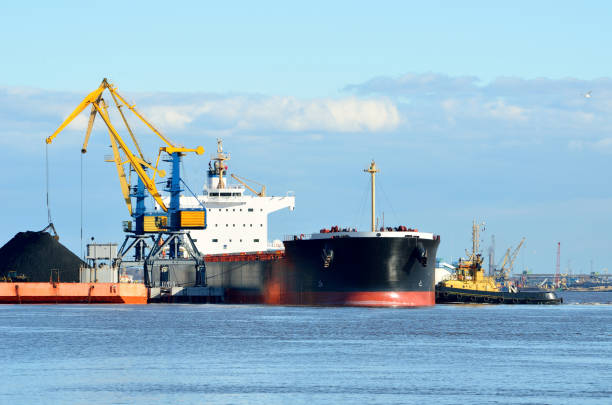 istock port cargo cranes and ship fragment at the docks 913009488