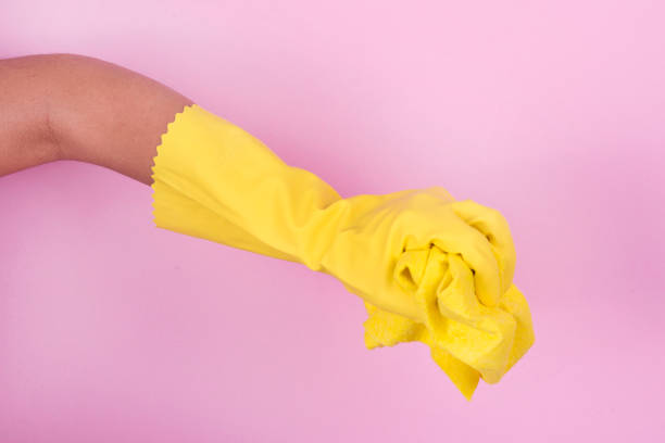 istock Hand in yellow protective glove cleaning with rag 913010196