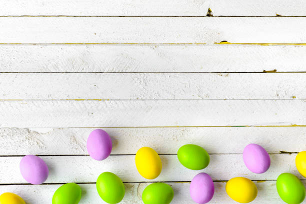 istock Spring easter eggs on white wooden background, group of colorful eggs, top view 913011008