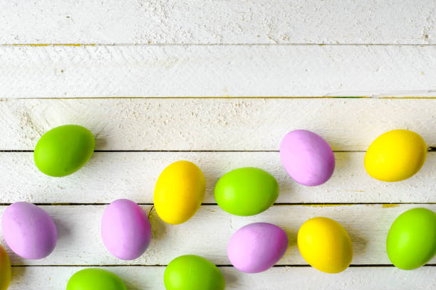 istock Easter eggs on wooden background, white boards with group of eggs in pastel colored 913013162