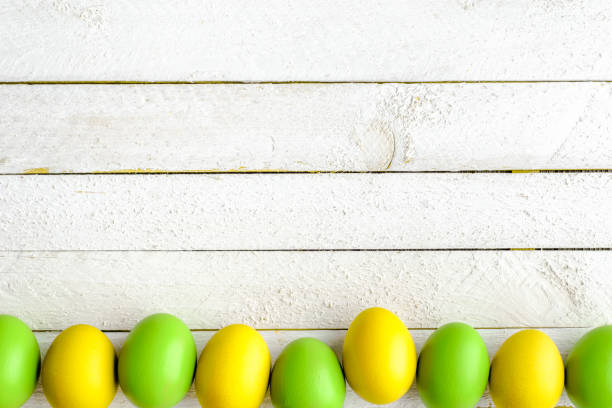 istock Spring easter eggs background, seasonal colored eggs on white wooden boards 913013210