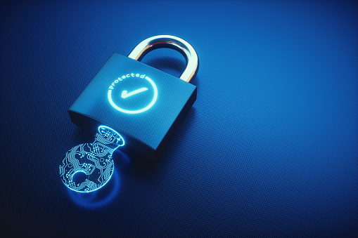 Close up on a padlock lying on a blue carbon fibre surface. The padlock is locked, with a digital key inserted and displays a glowing OK symbol.

