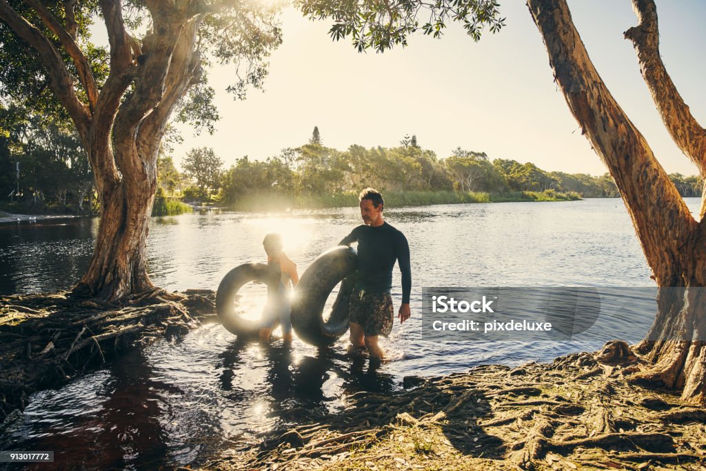 That was some tubular fun Shot of a father and son enjoying a day outdoors Men Stock Photo