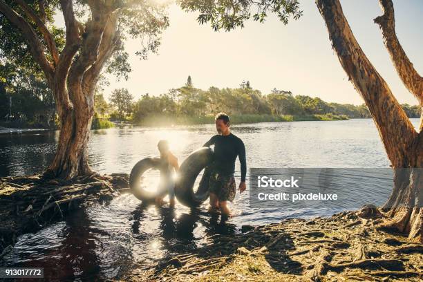 That Was Some Tubular Fun Stock Photo - Download Image Now - Men, Inflatable Swim Ring, River