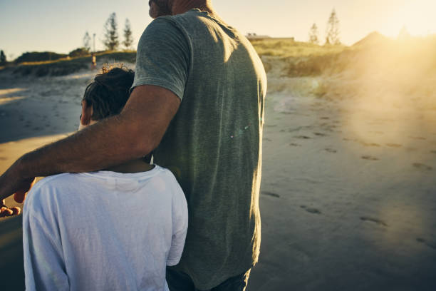 It is important to have father and son time Shot of a father and son enjoying a day outdoors arm around stock pictures, royalty-free photos & images