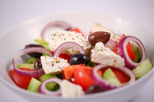 Greek salad with fresh vegetables: fresh tomato, cucumbers, fresh pepper, red onion, olives, cheese, marjoram