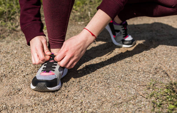 istock woman lacing shoe 913035930