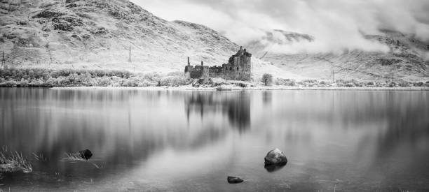 Argyll and Bute, Scotland - July 27, 2015: Looking across the still waters of Loch Awe in Scotland towards the ruins of Kilchurn Castle.