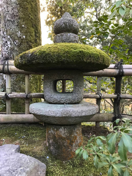istock Stone lantern in Japanese garden covered with moss 913036302