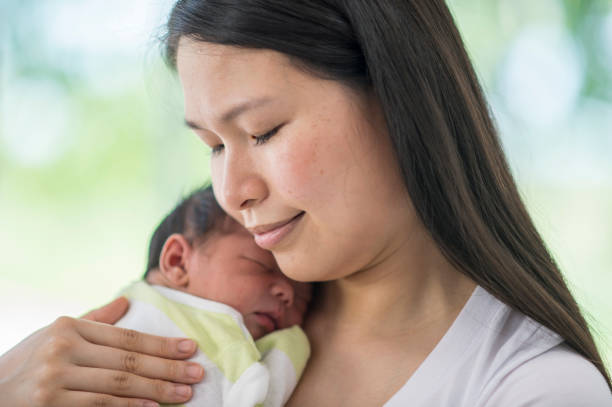 istock Mother Carrying Her Baby 913042554